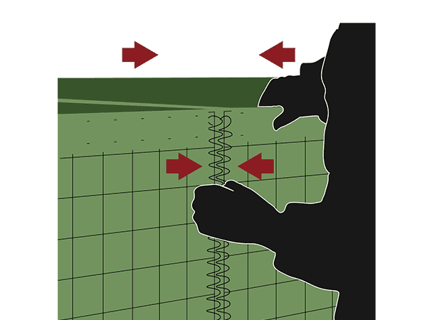 A worker is butting together the neighbour defensive barriers.