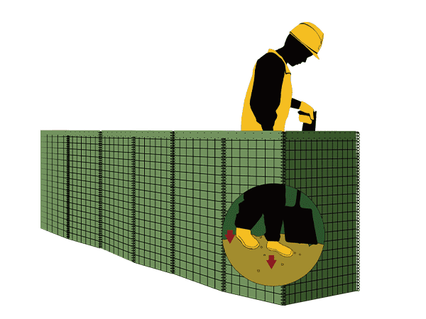 A worker is compacting the material in the cells of defensive barrier