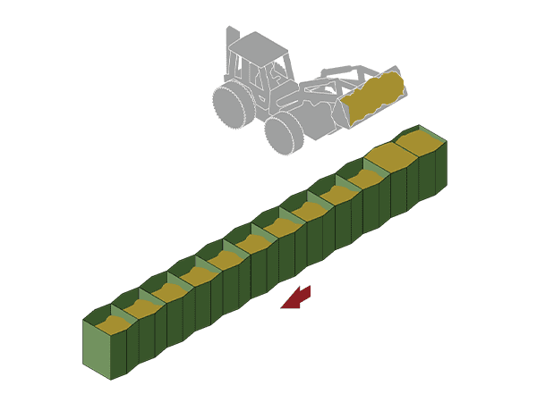 A excavator is filling material in the cells.