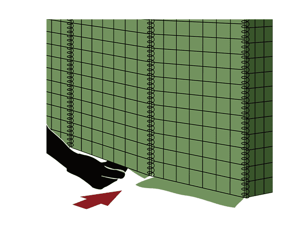 A worker is tucking the geotextile flaps defensive barriers in.