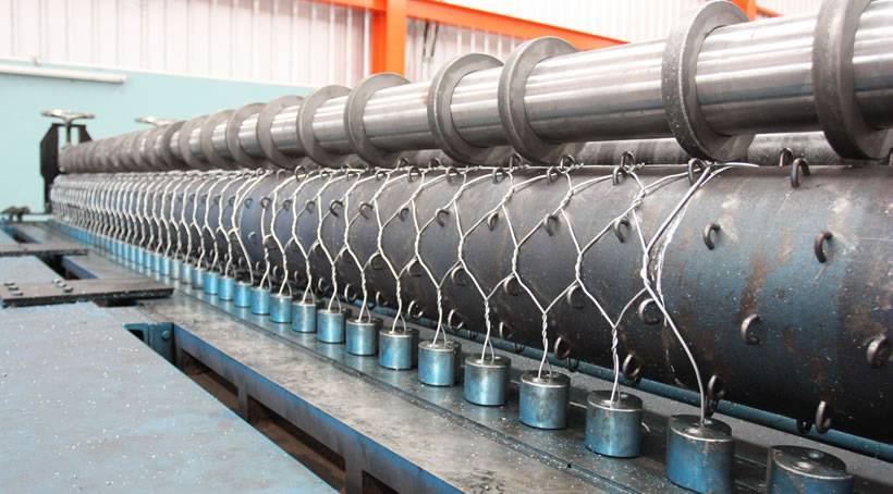A woven machine is producing double twisted hexagonal woven gabion.