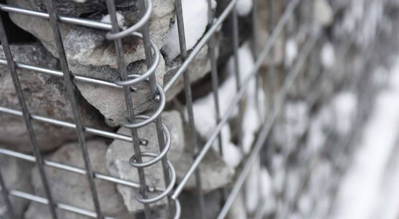 A detail of welded gabions filled with stones.